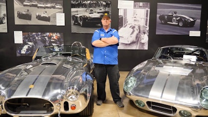 Richard Sparkman standing with two cars